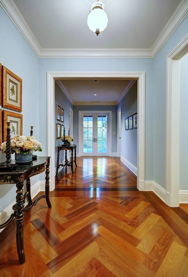 a glamor traditional hall with polished Brazilian walnut floor and white trim