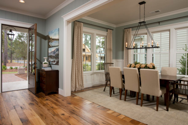 a timeless traditional entry and dining room with wood floor and white trim