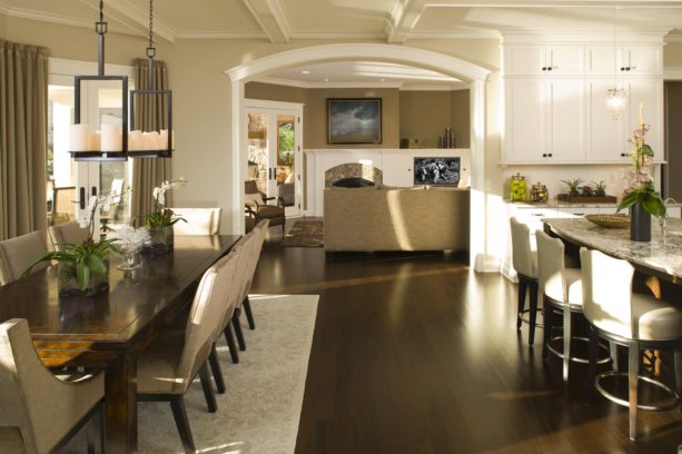 a traditional kitchen dining area with dark hardwood floor and white trim