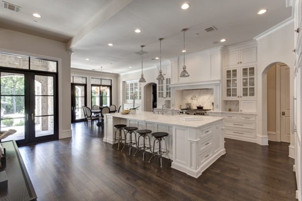 a traditional kitchen with white trim and ebony-stained white oak floor