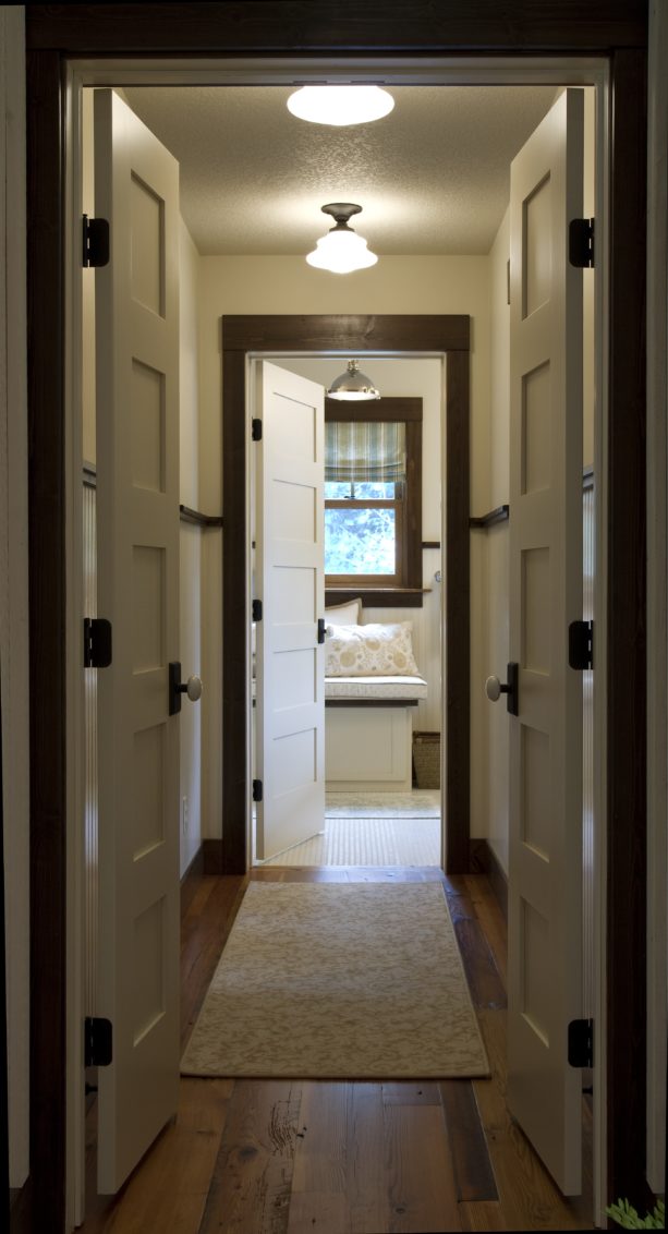 white doors and dark stained wood trim in an elegant hallway