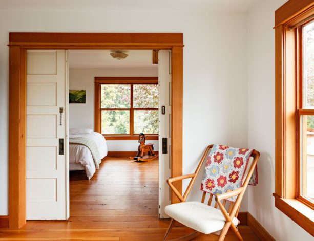 white sliding doors paired with an orangish wood trim