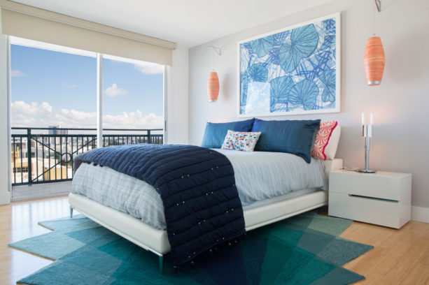 a balanced and sophisticated contemporary bedroom with coral, navy blue, and white color scheme