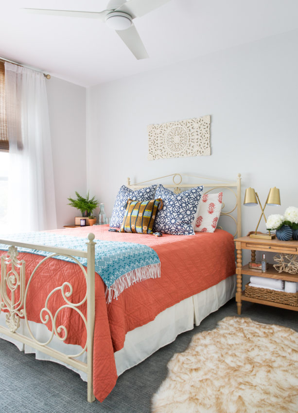 a coral bedding and blue blanket to update a bedroom look