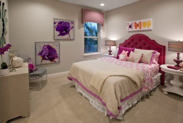 a cozy contemporary girl’s bedroom with pink, purple, and light tan color scheme