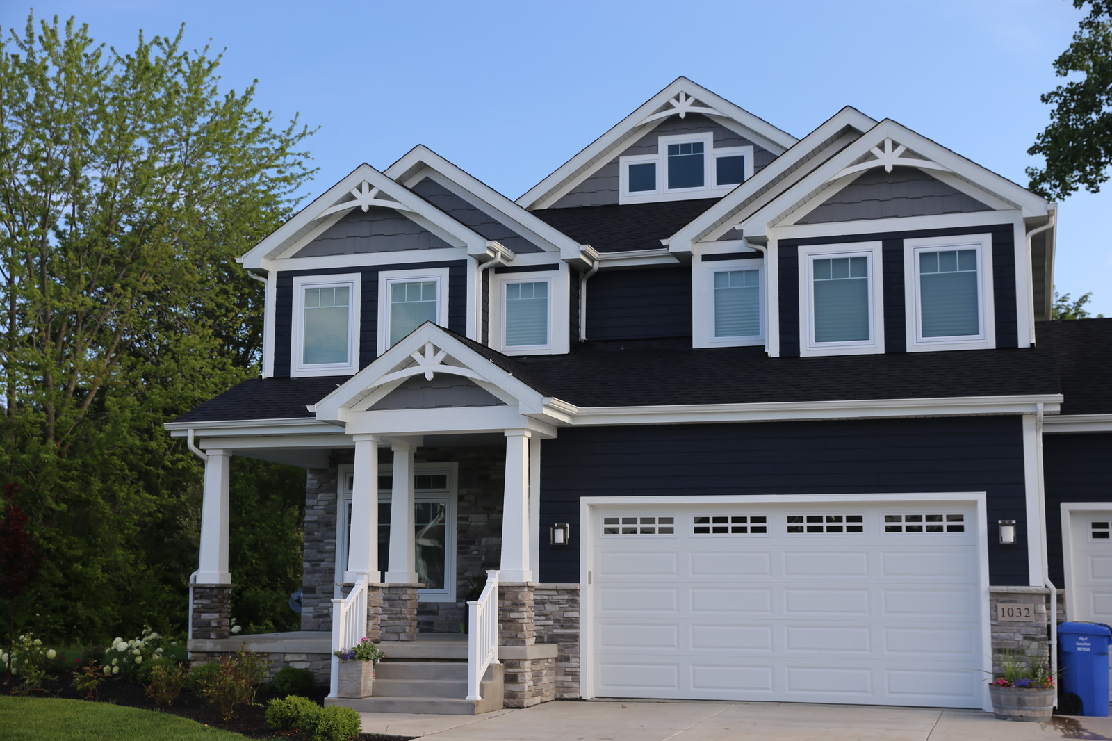 6 Best Blue House White Trim Combinations For Your Exterior Design   A Dark Navy Craftsman House With White Trim 