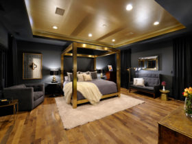 a luxurious eclectic bedroom with black, gold, and grey colors