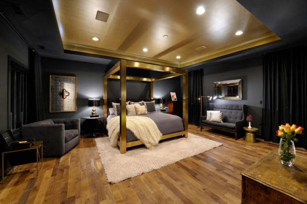 a luxurious eclectic bedroom with black, gold, and grey colors