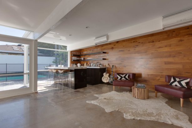 a mid-century modern family room with polished concrete floor
