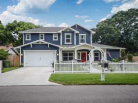 a navy blue house with white trim and red door