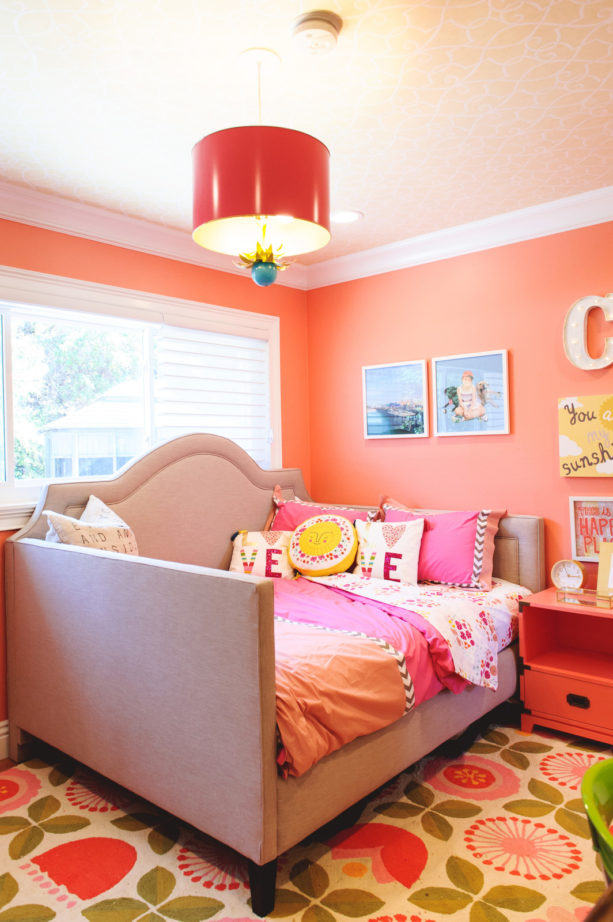 a transitional multicolor girl’s bedroom in coral pink and soft purple color