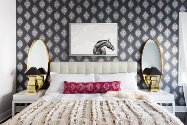an eclectic bedroom with symmetrical black and gold decor