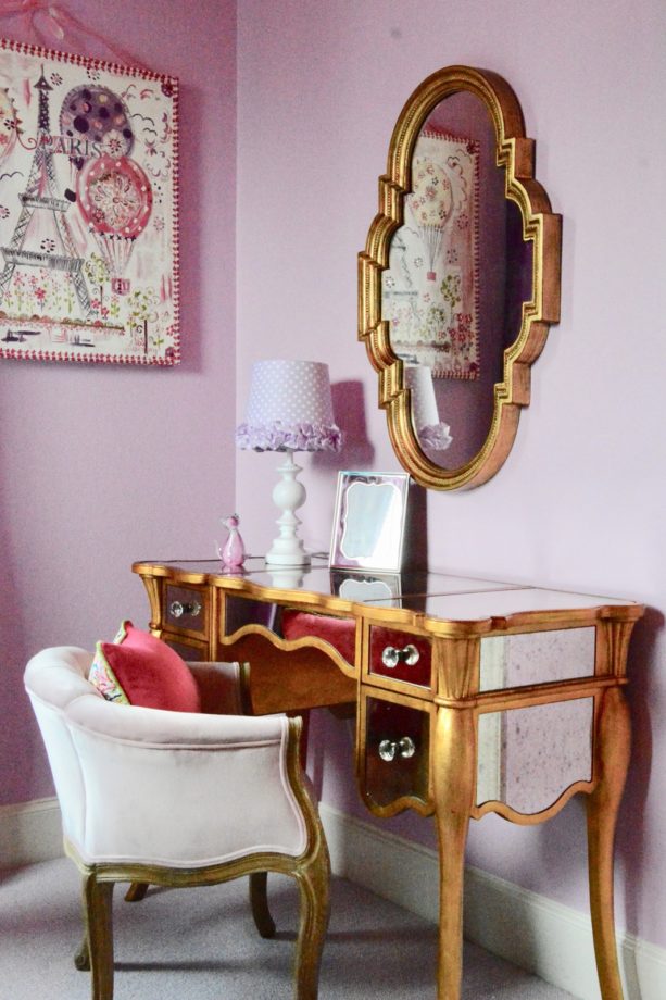 the gold dressing table in the corner of the room