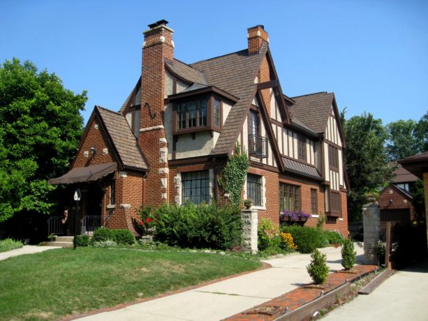 a victorian brown brick house with brick roof