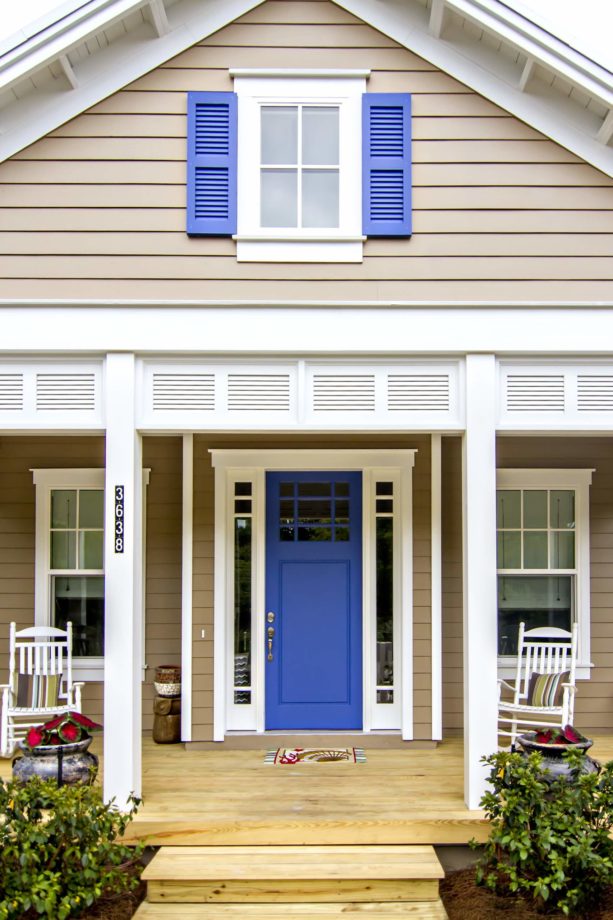 a tan beach-style house with blue shutters