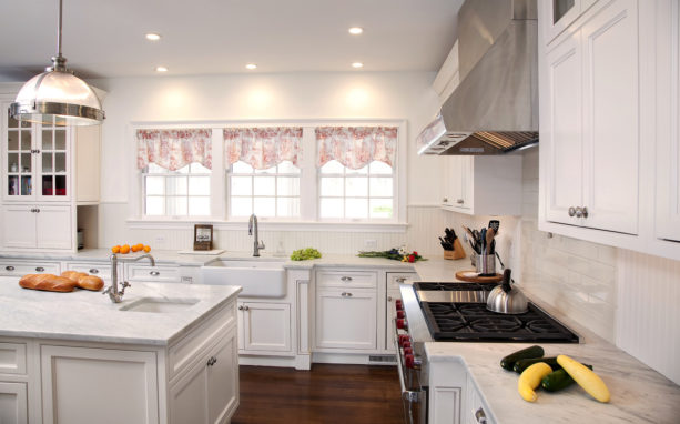 the combination of white subway tile, white grout, and white beadboard in a traditional kitchen backsplash