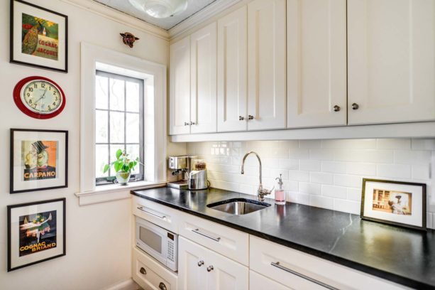 white subway tile and white grout paired with antique white cabinets