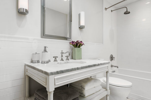 white subway tile with white grout paired with silver accents in a transitional bathroom