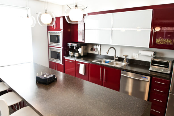 an elegant contemporary kitchen with red, black, and white color scheme