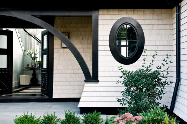 an ivory white wall shingles with black trim in a modern-Victorian entry