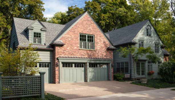 sage green siding and red brick combination for creating a timeless exterior