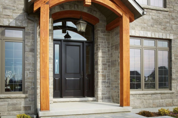 a custom black front door with sidelights and an oversized transom window