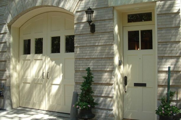 a custom front door with transom that matches the garage door style