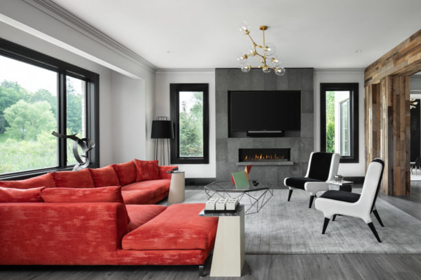 a grey transitional living room with stunning red sectional