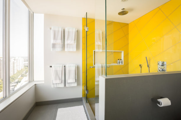 yellow shower room in a modern grey bathroom