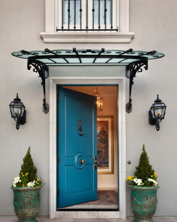 a blue front door with mitered casing in a traditional home exterior design