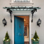 a blue front door with mitered casing in a traditional home exterior design