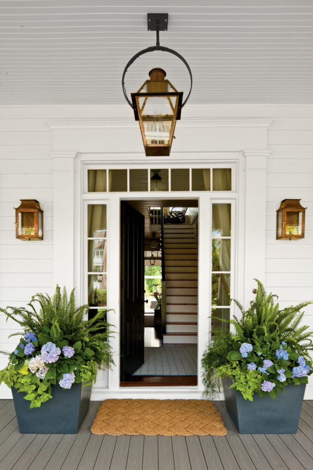 trim with decorative details in a black front door design with transom and sidelights