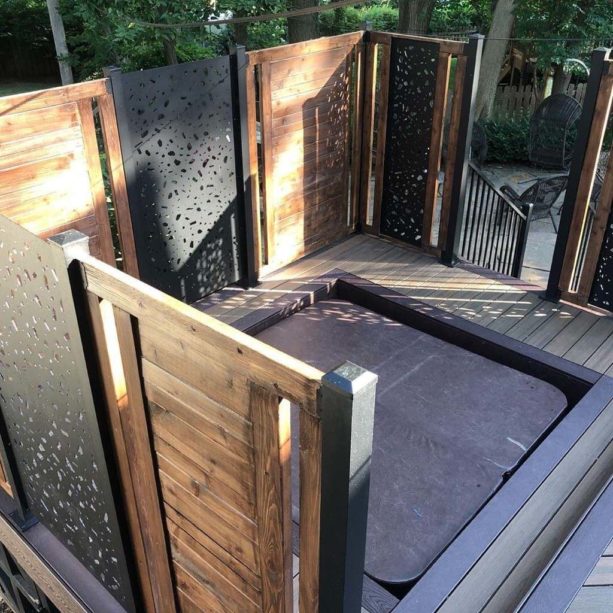 laser cut privacy screens paired with horizontal wood wall for the built-in hot tub in the deck