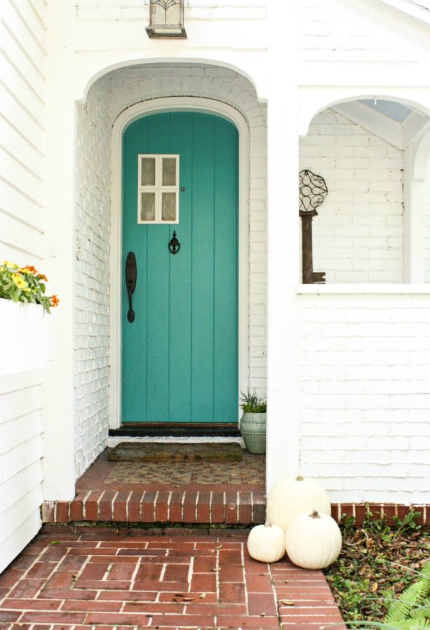 a white-painted brick entry with refreshing blue door