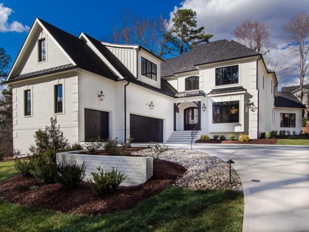 the pairing between white painted brick and black roof shingle in a transitional exterior