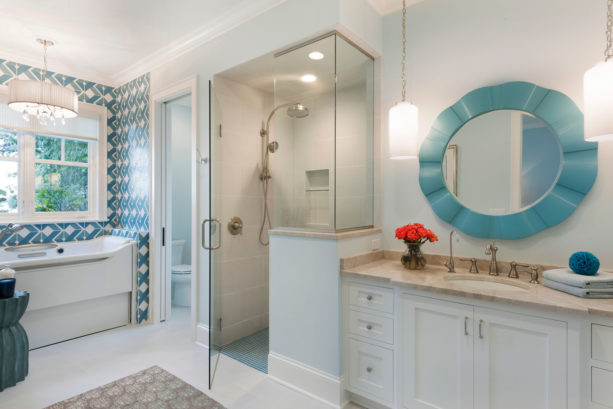 an elegant master bathroom with Tosca colored mirror in the blue and white color scheme