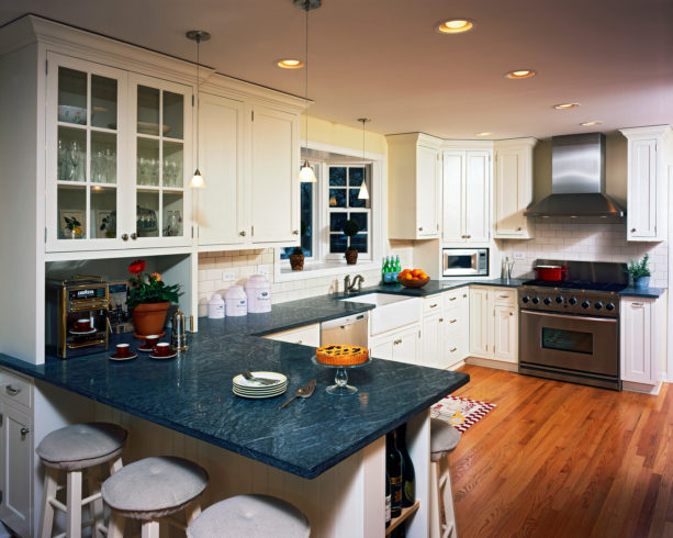 blue black soapstone countertops in spotless white cabinets for a farmhouse kitchen