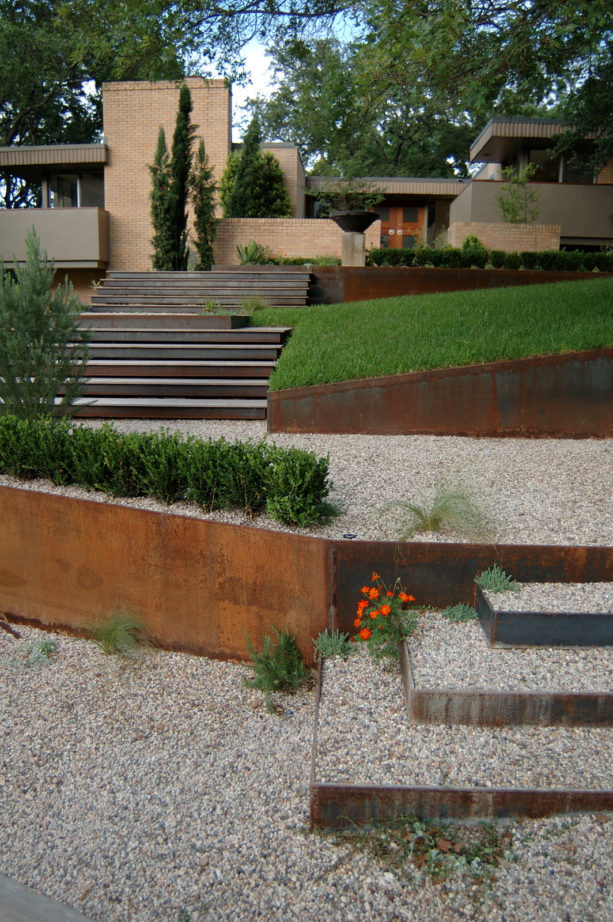 contemporary metal retaining wall landscape ideas with stoned steep slopes