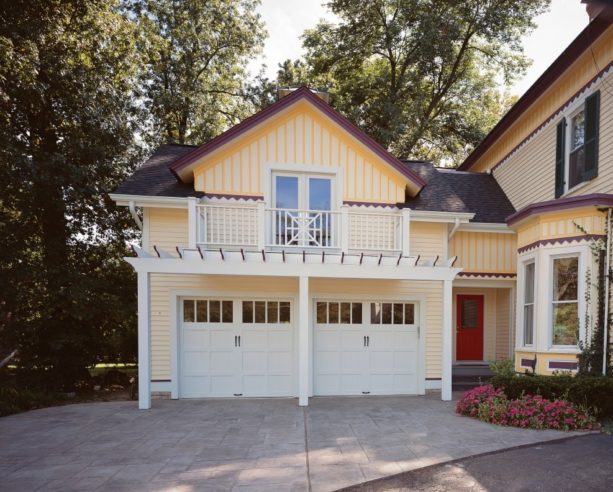 mid-sized ornate carport in front of painted white garage’s door