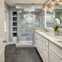 modern master bathroom without tub featuring a long vanity and quartzite countertops