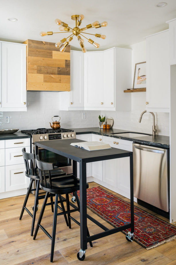 tiny cozy kitchen with white ikea cabinets and black quartzite countertops