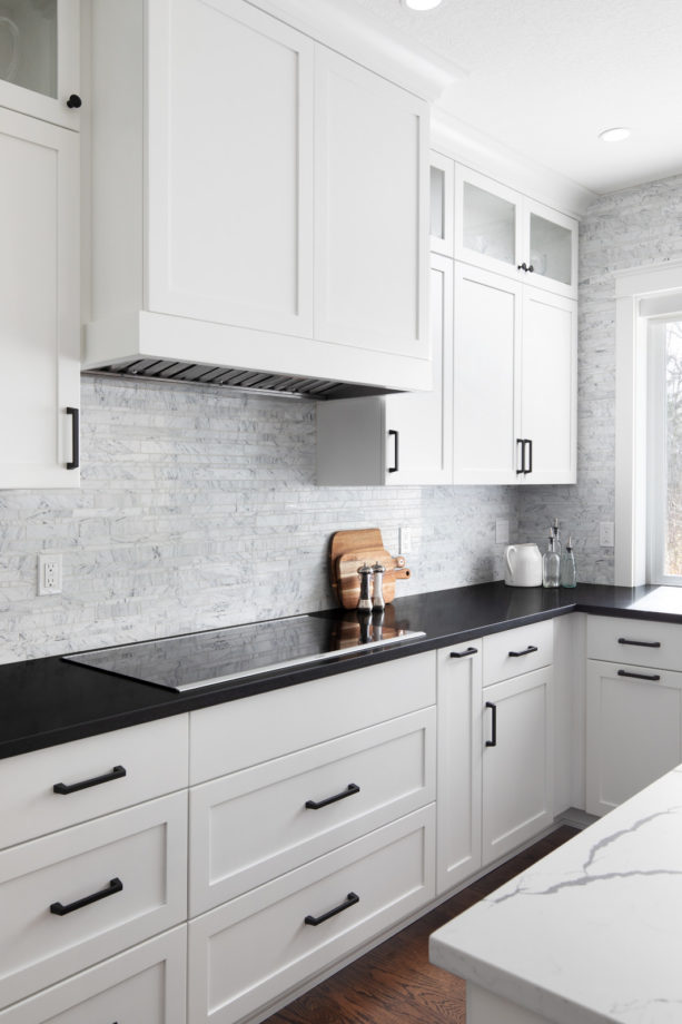 U Shaped Shaker White Cabinets And Black Granite Countertops In A Contemporary Kitchen 613x920 