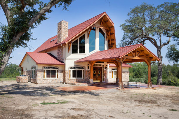 timber frame post and beam carport in a mountain style house exterior