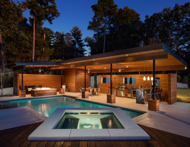 a large modern backyard with stamped concrete, pool, and spa