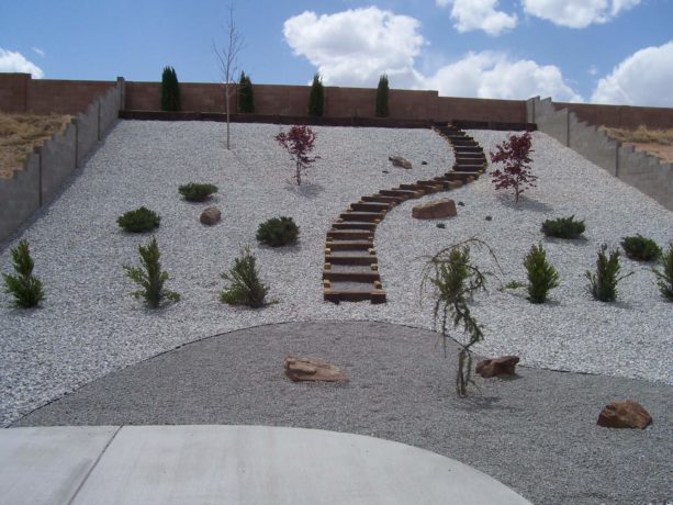 desert white gravel backyard landscape idea in a steep slope