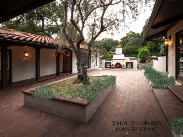 old california mission style home and a courtyard with spanish style outdoor fireplace