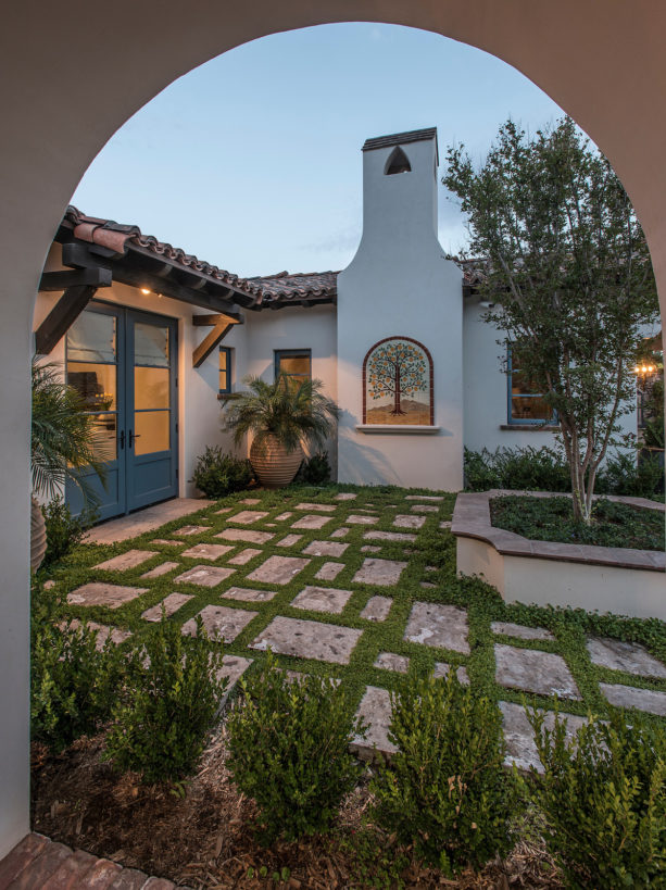 spanish colonial style home featuring a private courtyard