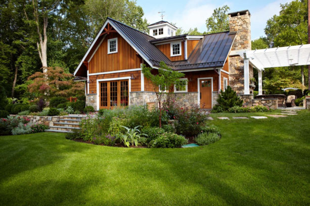 stunning house color combination of stained cedar shakes siding and metal roof