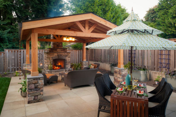 architectural slabs covered patio with custom wood burning fireplace