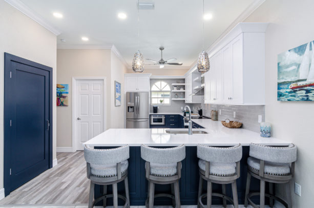 blue and white kitchen in u-shaped layout and a peninsula